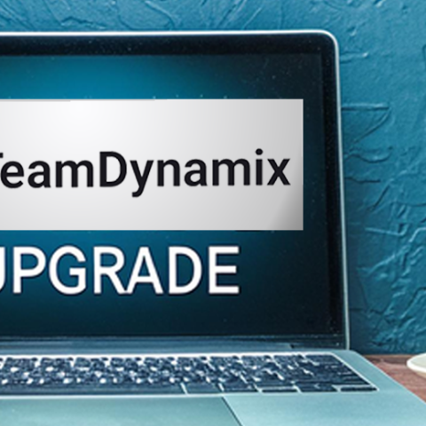 A laptop displaying the words "TeamDynamix Upgrade"